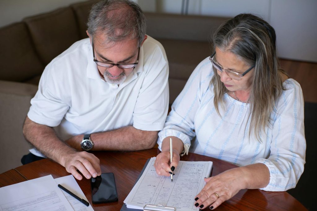 Investor reviewing NNN property documents inside a self-directed IRA account in 2026, net lease cap rate data on desk